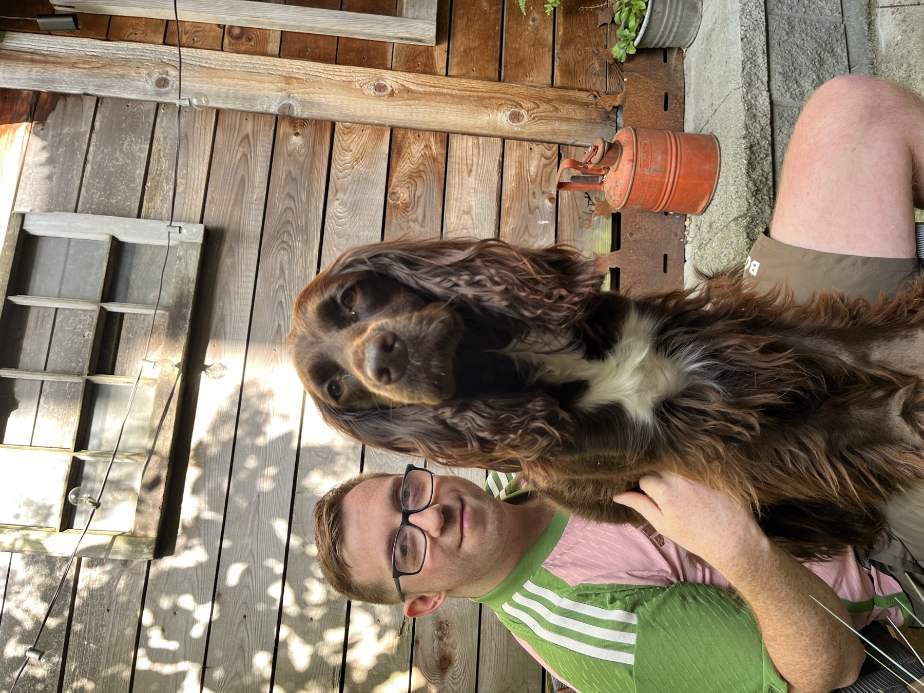 Tilly sitting with us on the small wooden patio at the Commercial Drive Airbnb