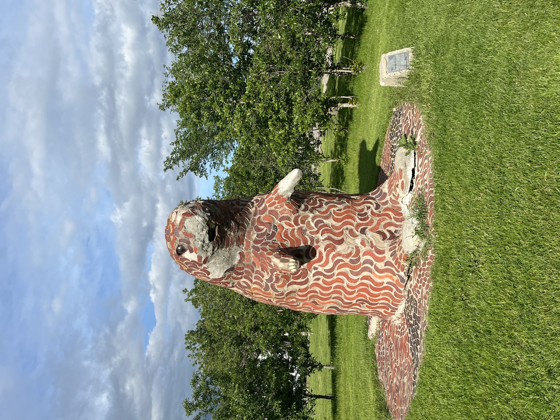A large mosaic animal sculpture beside the route