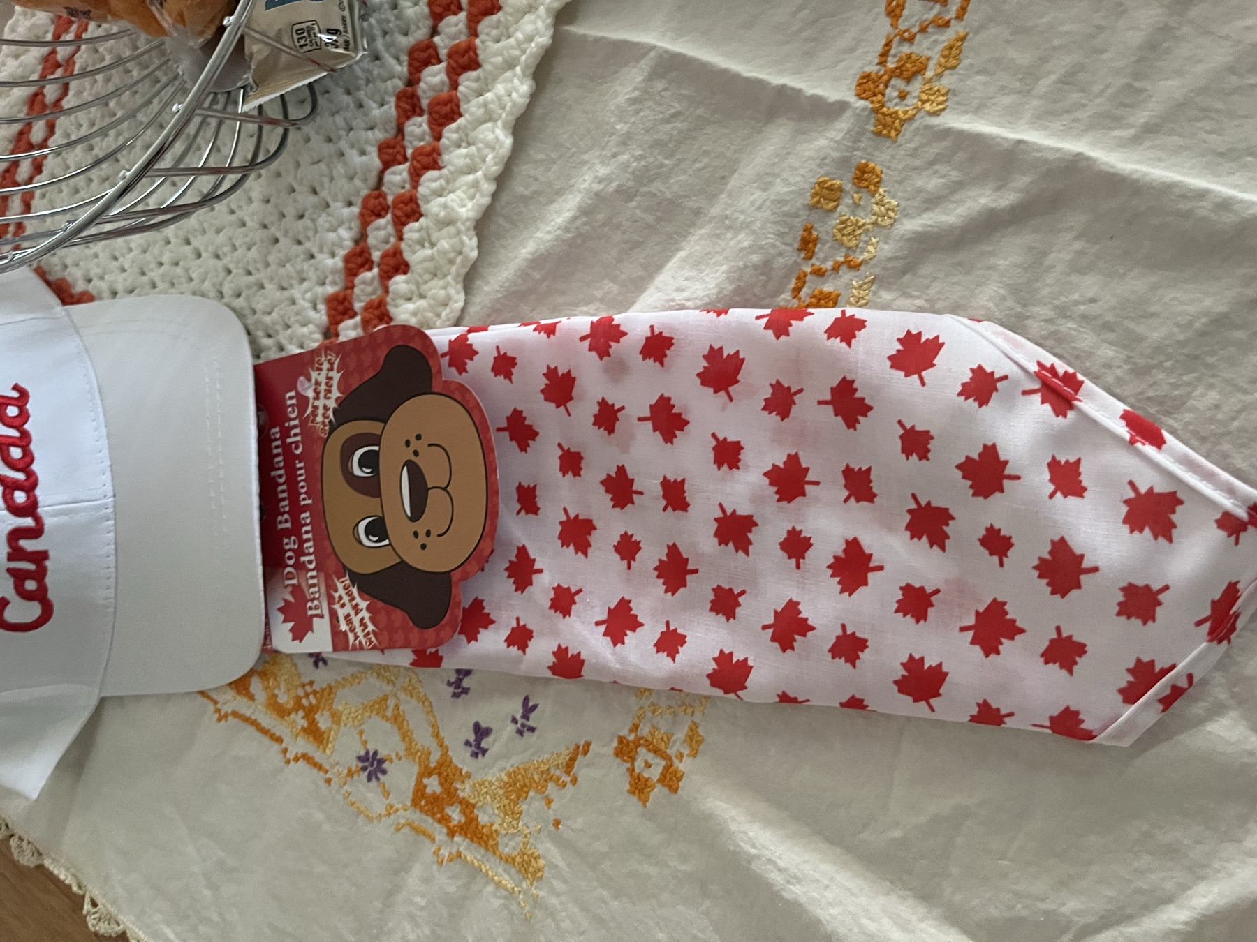 A Canada hat and maple-leaf dog bandana left by the Airbnb host