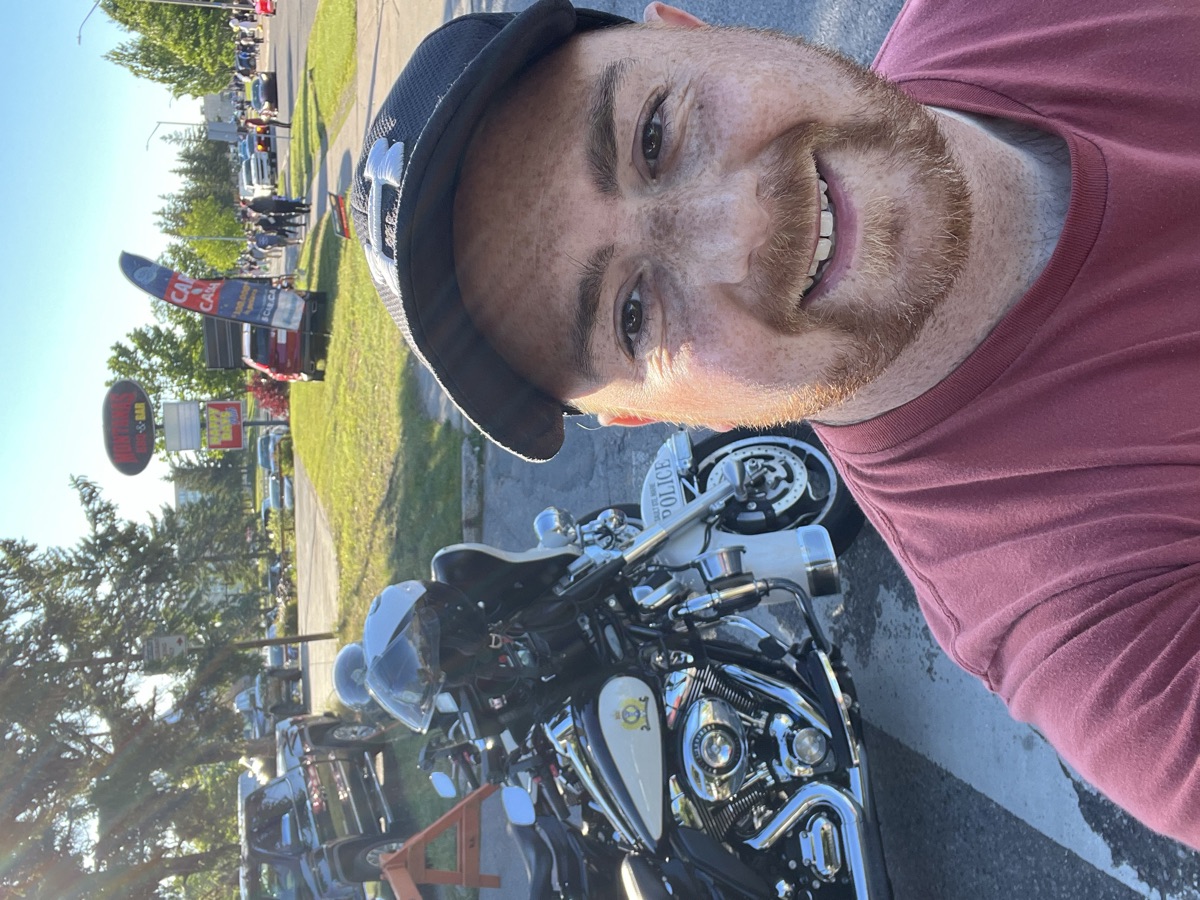 Shaun beside a police motorcycle at the classic-car event