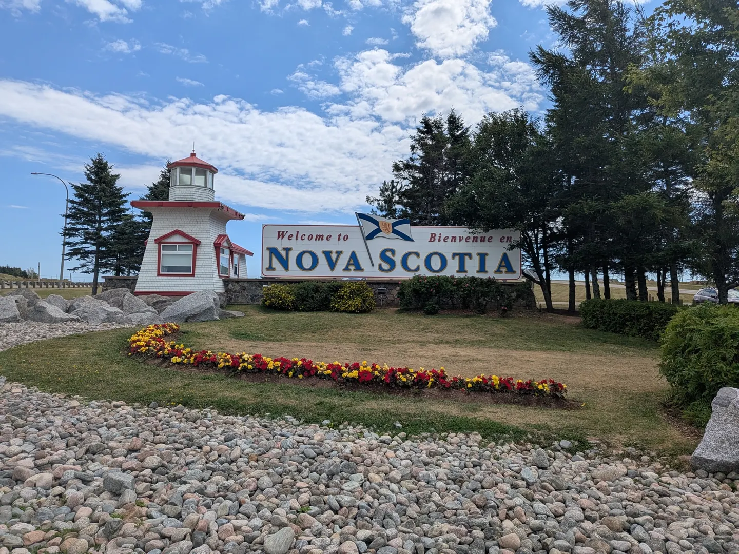 The Welcome to Nova Scotia sign beside its lighthouse at the visitor centre